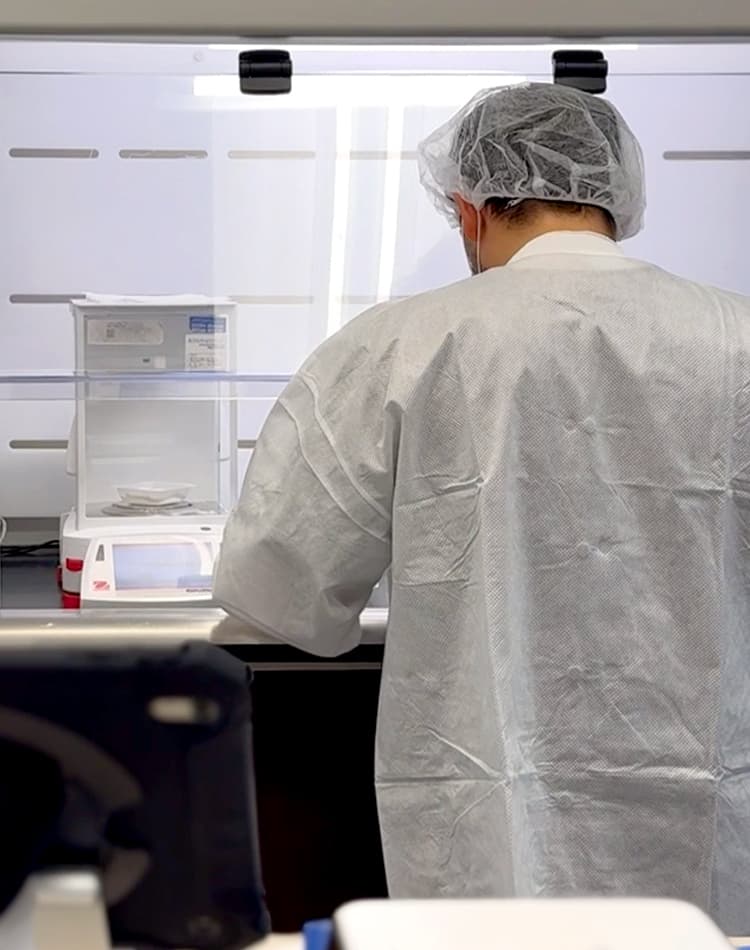 Pharmacist working in laboratory with protective gear