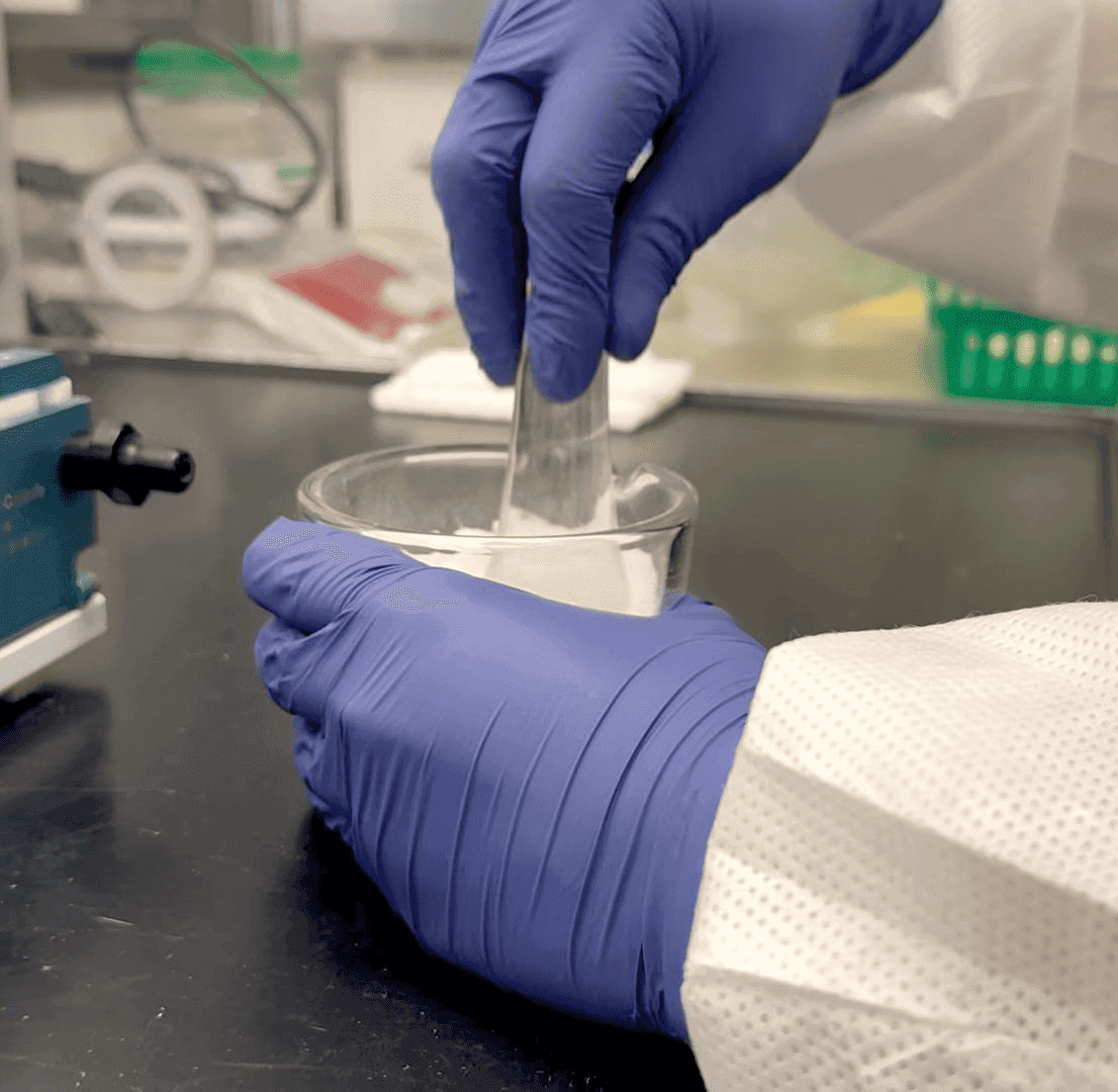 Pharmacist using mortar and pestle with medication bottles